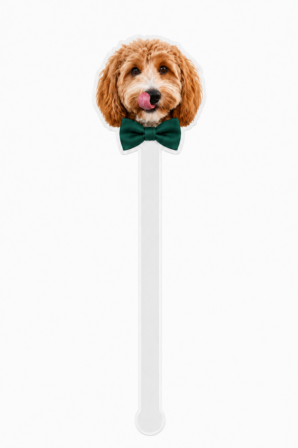 Dog-shaped spoon with a green bow tie on a white background