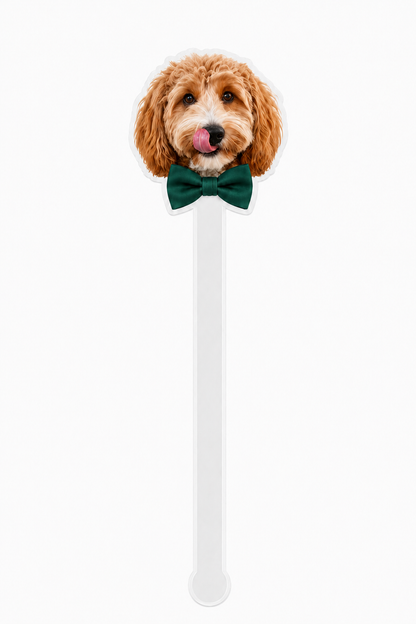 Dog-shaped spoon with a green bow tie on a white background