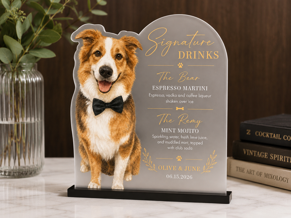 Dog-shaped sign with cocktail menu on a table with books and a vase.