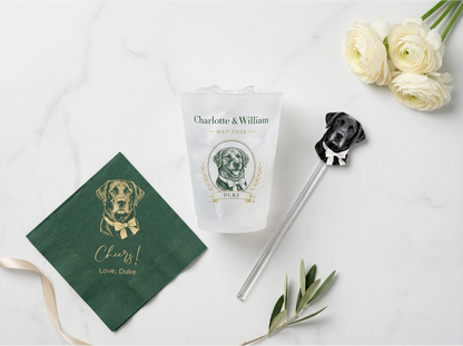 Personalized dog-themed items including a napkin, tumbler, and straw on a white surface with flowers.