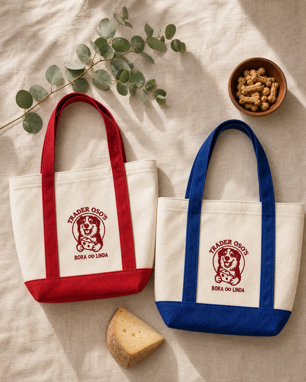 Two tote bags with Trader Joe's logo on a light fabric background.