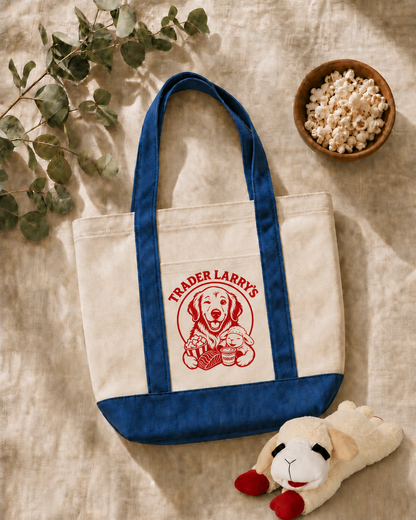 Tote bag with 'Trader Larry's' logo, plush toy, and bowl of popcorn on a textured surface.