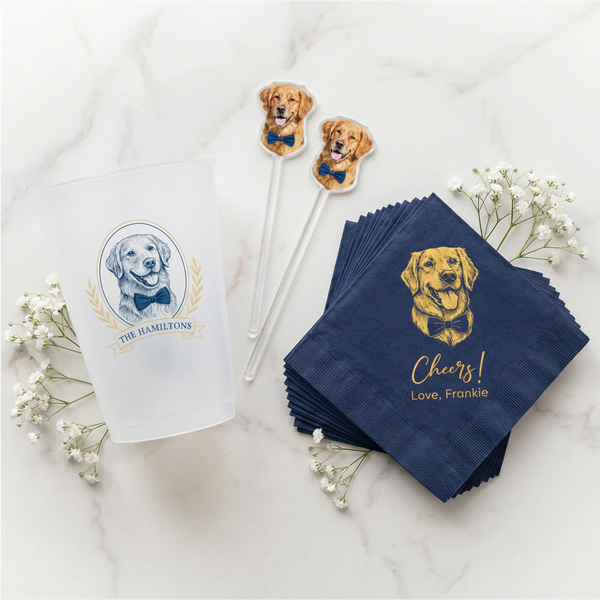 Napkins with dog illustration and text, accompanied by decorative sticks and flowers on a marble surface.